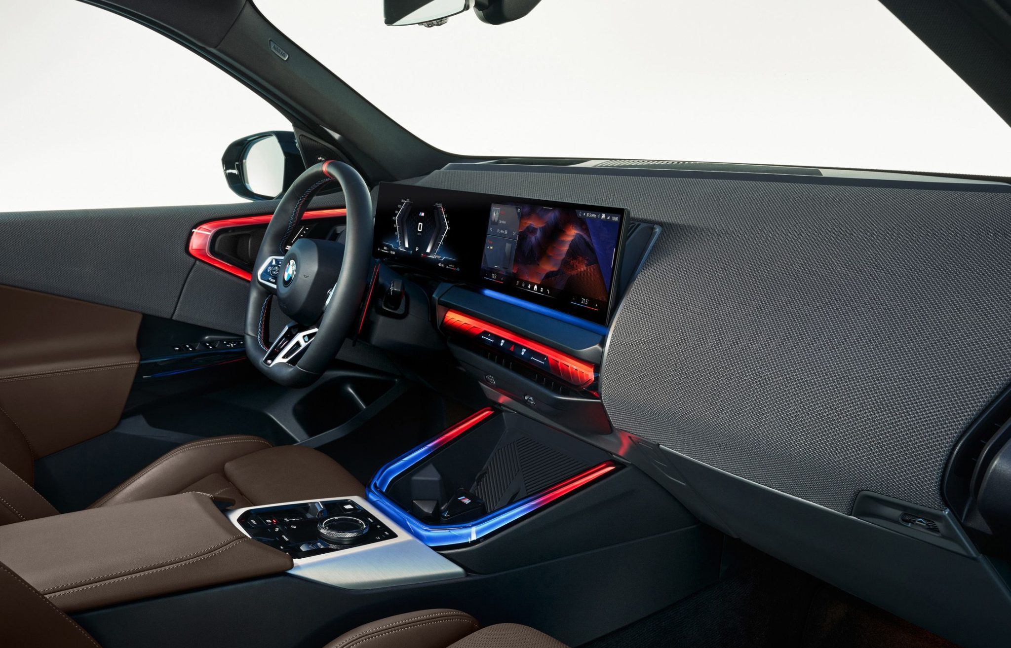 Another interior shot of the BMW X3 xDrive30i, showcasing its iDrive 8 system, ambient lighting, and spacious rear seats.