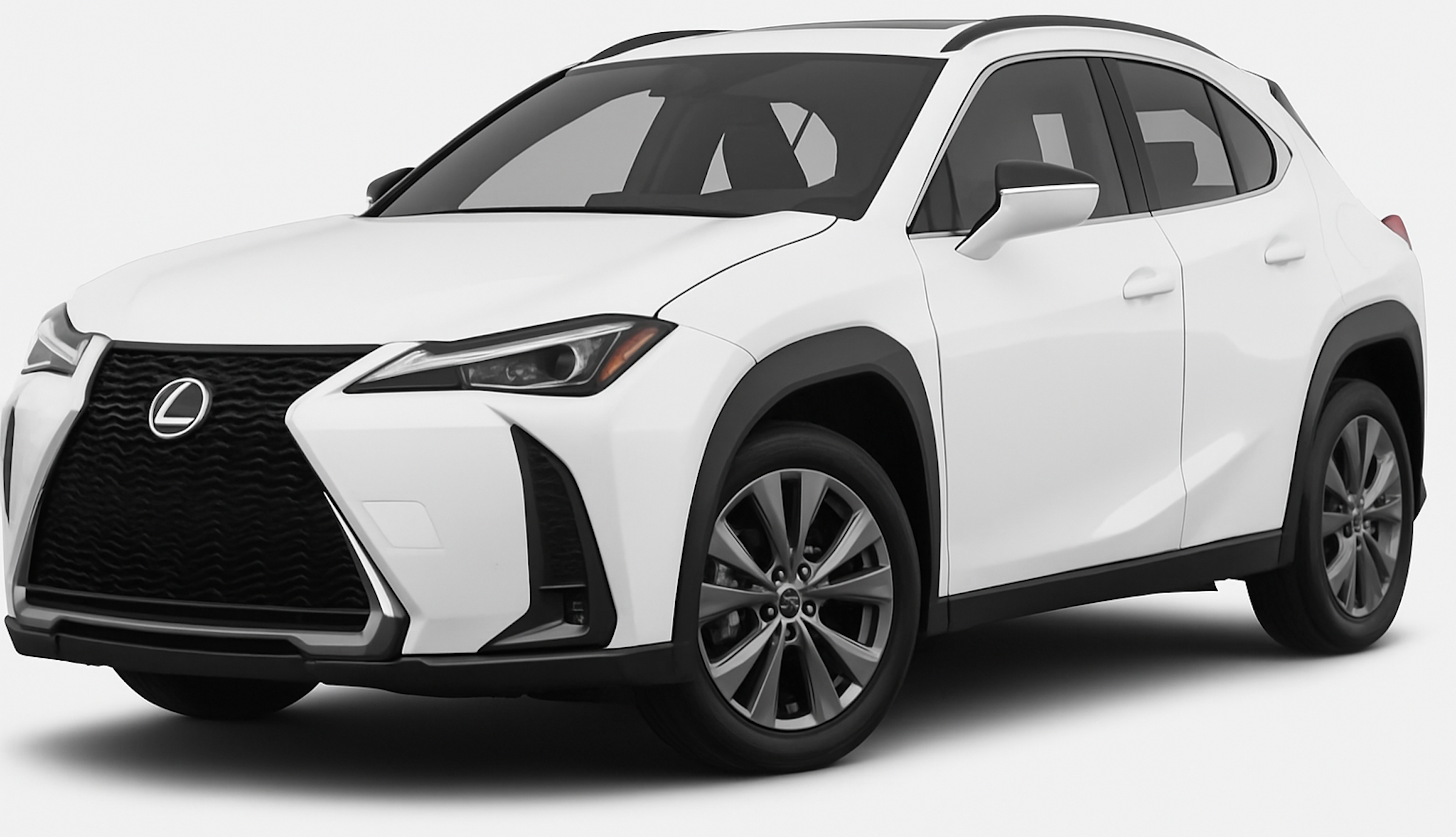 Front view of the 2025 Lexus UX 300h in white, featuring Lexus’ signature spindle grille, angular LED headlights, and an aerodynamic front bumper design.