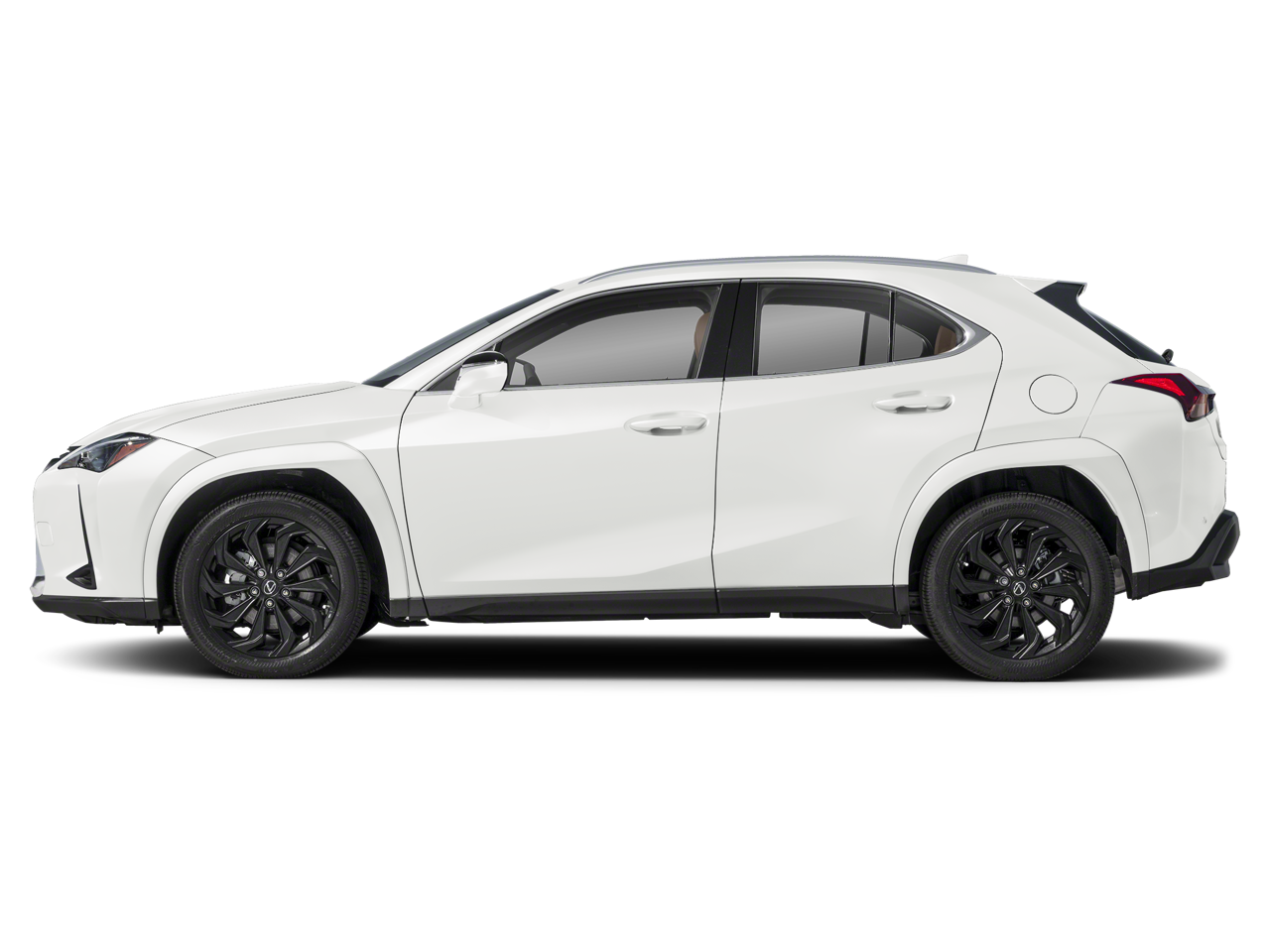 Side profile of the 2025 Lexus UX 300h in white, highlighting its compact crossover design, sharp body lines, black wheel arch cladding, and stylish alloy wheels.