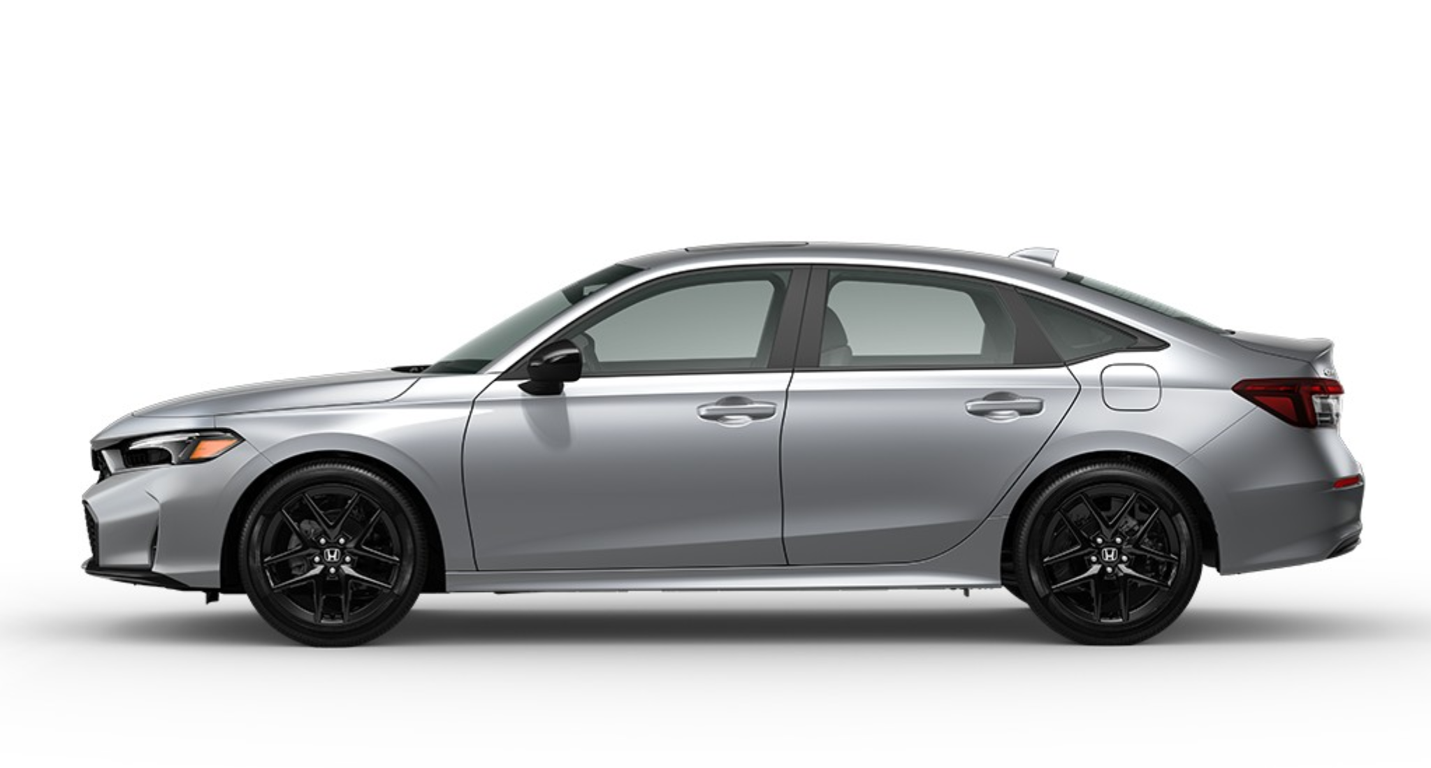 Side profile of the silver 2025 Honda Civic Sport Hybrid sedan showcasing aerodynamic lines and modern styling.