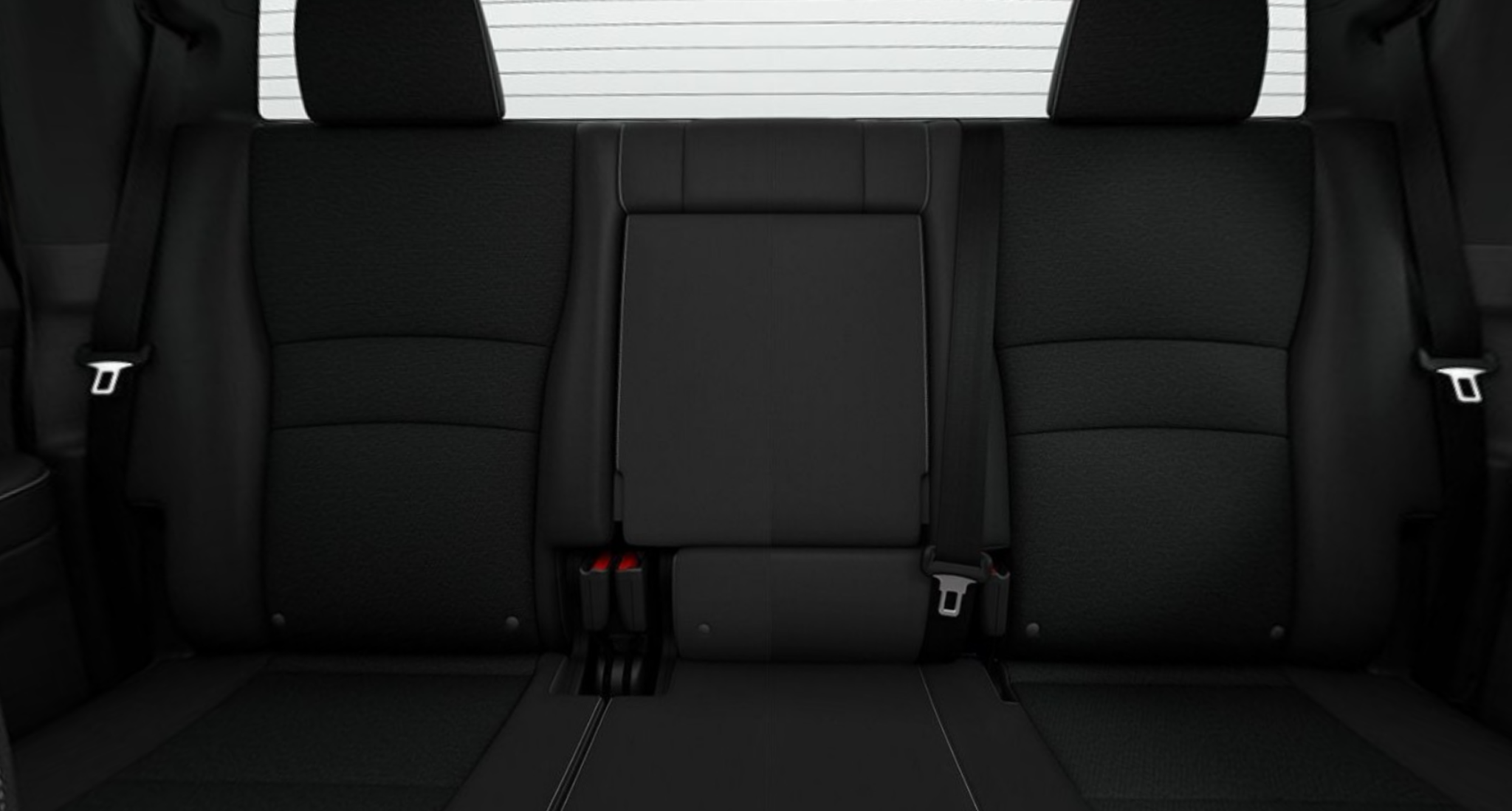 Rear seating of the 2025 Honda Ridgeline Sport, featuring black cloth seats with 60/40 split and under-seat storage for added functionality.