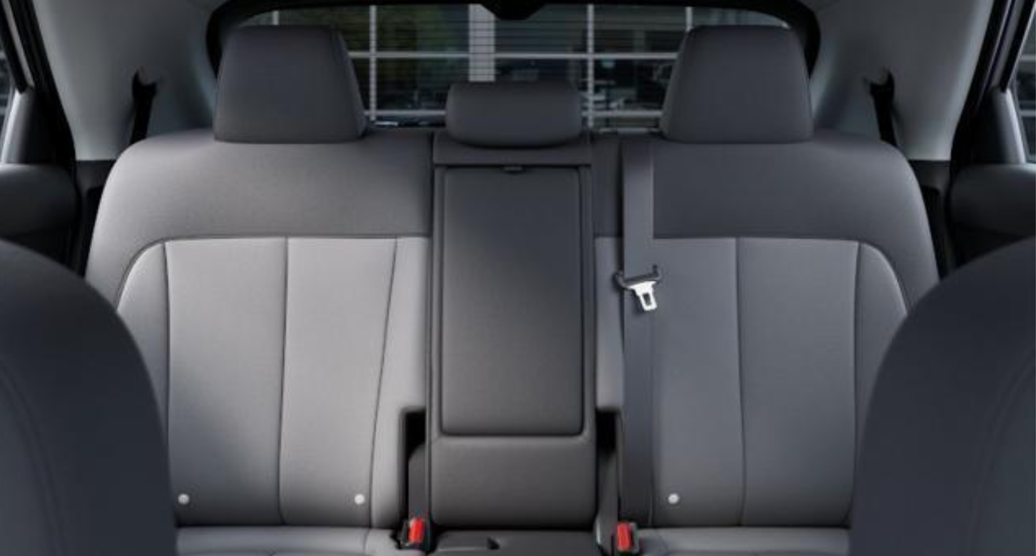 Rear seat view of the 2025 Hyundai Ioniq-5 RWD SE featuring dual-tone stain-resistant cloth upholstery, spacious seating, and a fold-down center armrest.