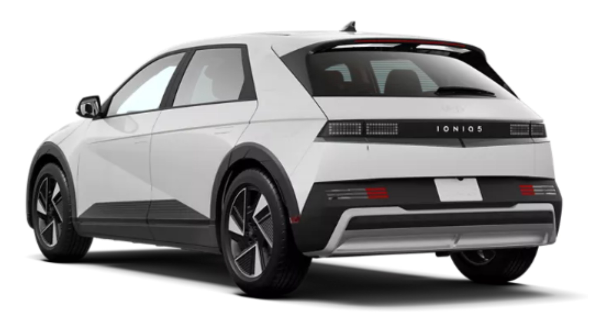 Rear exterior view of the 2025 Hyundai Ioniq-5 RWD SE in Atlas White, highlighting its LED pixel tail lights, rear spoiler, and aerodynamic design.