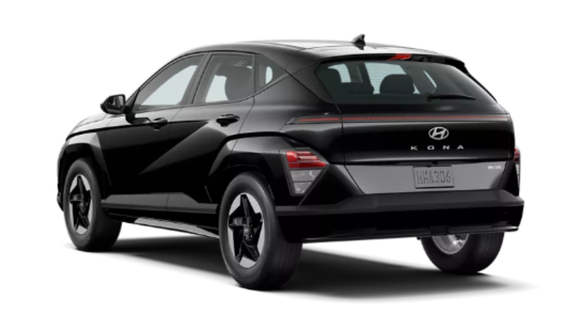 2025 Hyundai Kona Electric SE rear exterior view showing the sleek LED taillights, rear spoiler, and Kona badging in a black color finish.