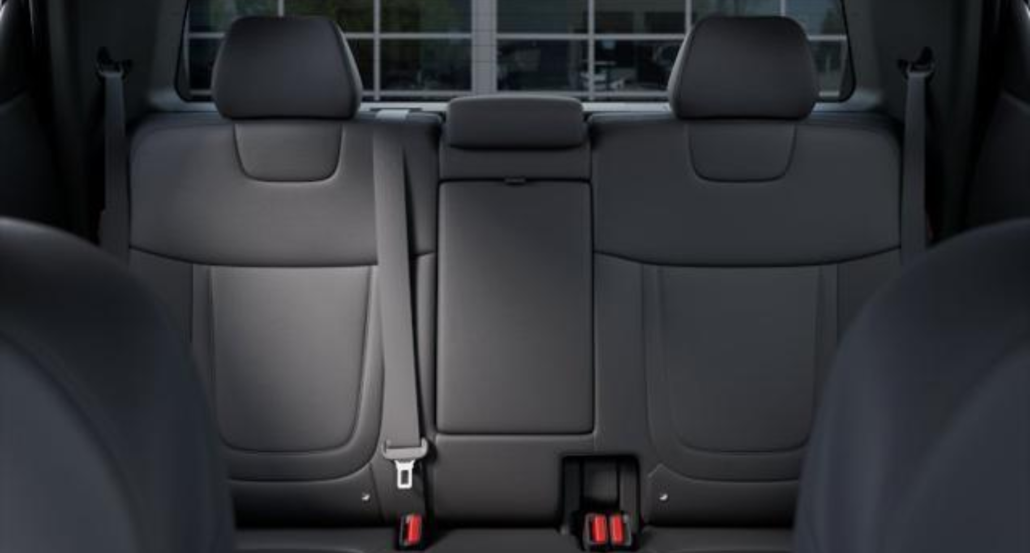 Rear seating of the 2025 Hyundai Santa Cruz SE, featuring stain-resistant cloth seats with adjustable headrests and 60/40 split-folding design for added cargo flexibility.