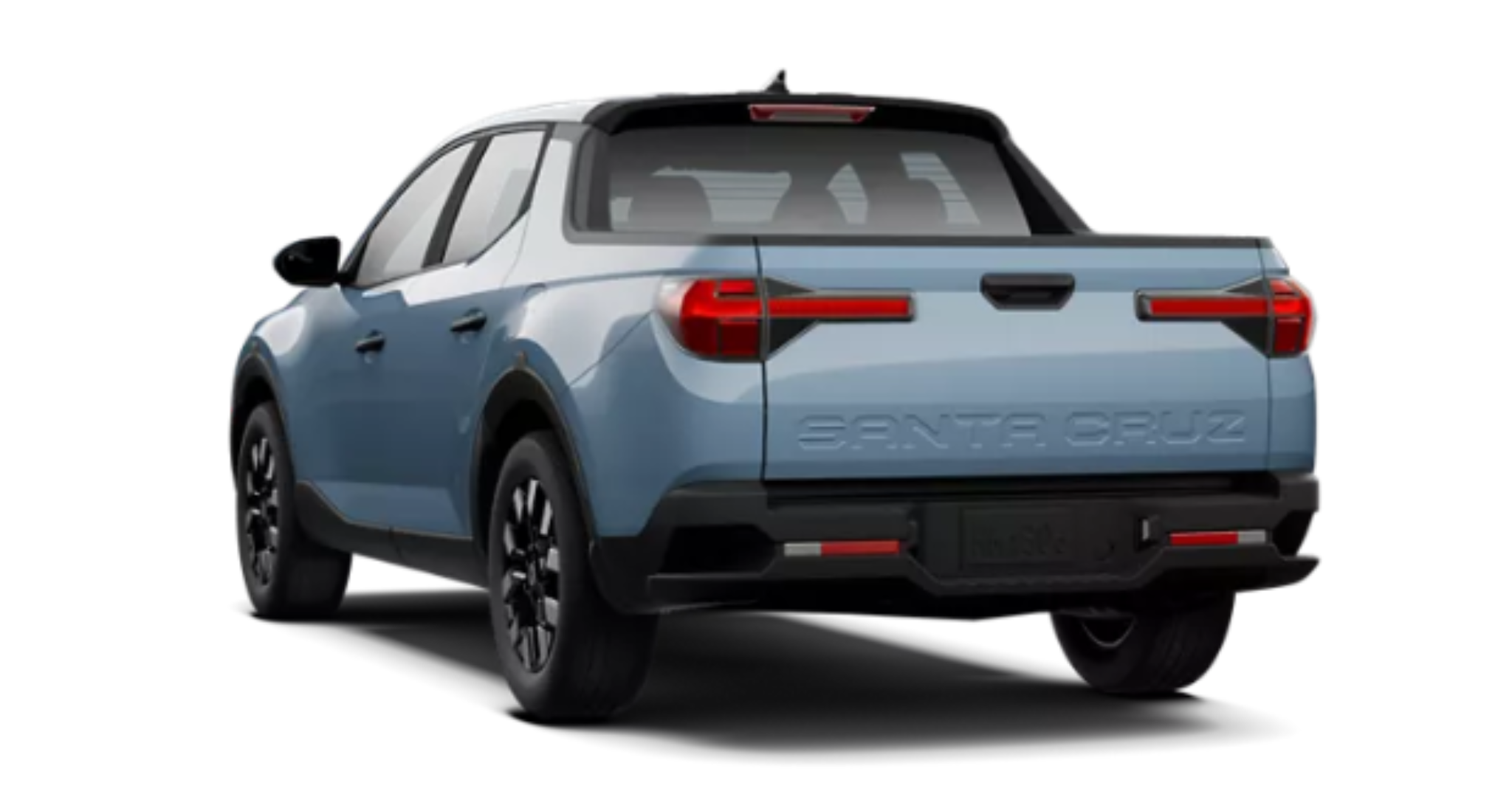Rear exterior of the 2025 Hyundai Santa Cruz SE, displaying LED tail lights, bold SANTA CRUZ tailgate branding, and integrated rear bumper steps for easy bed access.