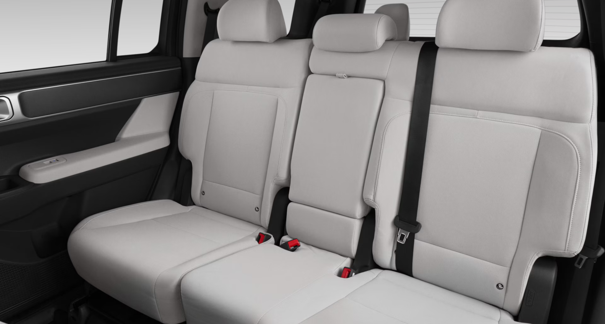 Rear seat view of the 2025 Hyundai Santa Fe SE showcasing spacious 7-passenger seating with light gray cloth upholstery and foldable seat configuration.