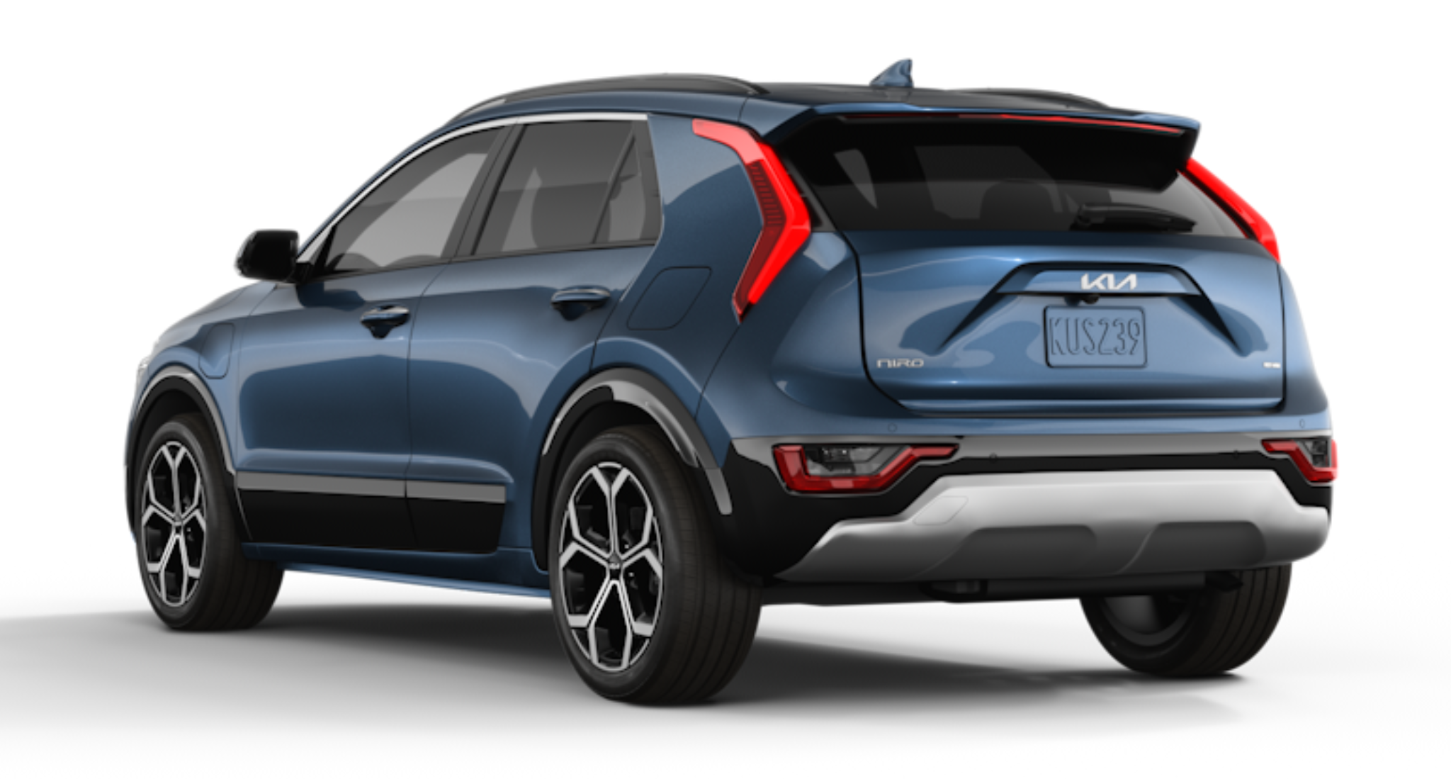 Rear exterior view of the 2025 Kia Niro PHEV EX in Cityscape Green, highlighting the LED rear combination lights, rear spoiler, and bold design lines that enhance aerodynamics and style.