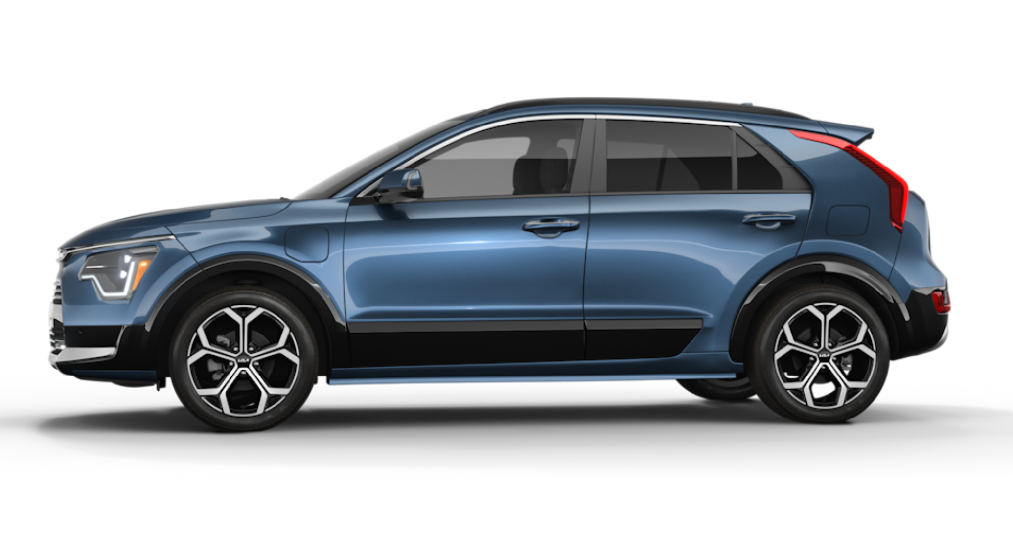 Side profile of the 2025 Kia Niro PHEV EX, displaying sleek aerodynamic lines, 16-inch Aero Alloy wheels, and a two-tone color scheme for a modern, sporty appearance.