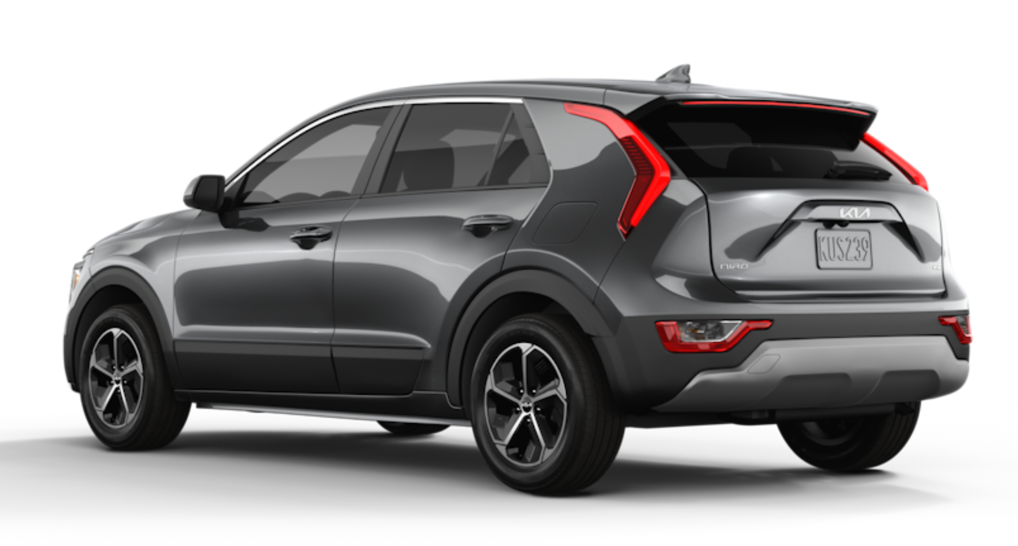 Rear view of the 2025 Kia Niro LX FWD in Steel Gray, highlighting its aerodynamic design, LED tail lights, rear spoiler, and black wheel arch moldings.