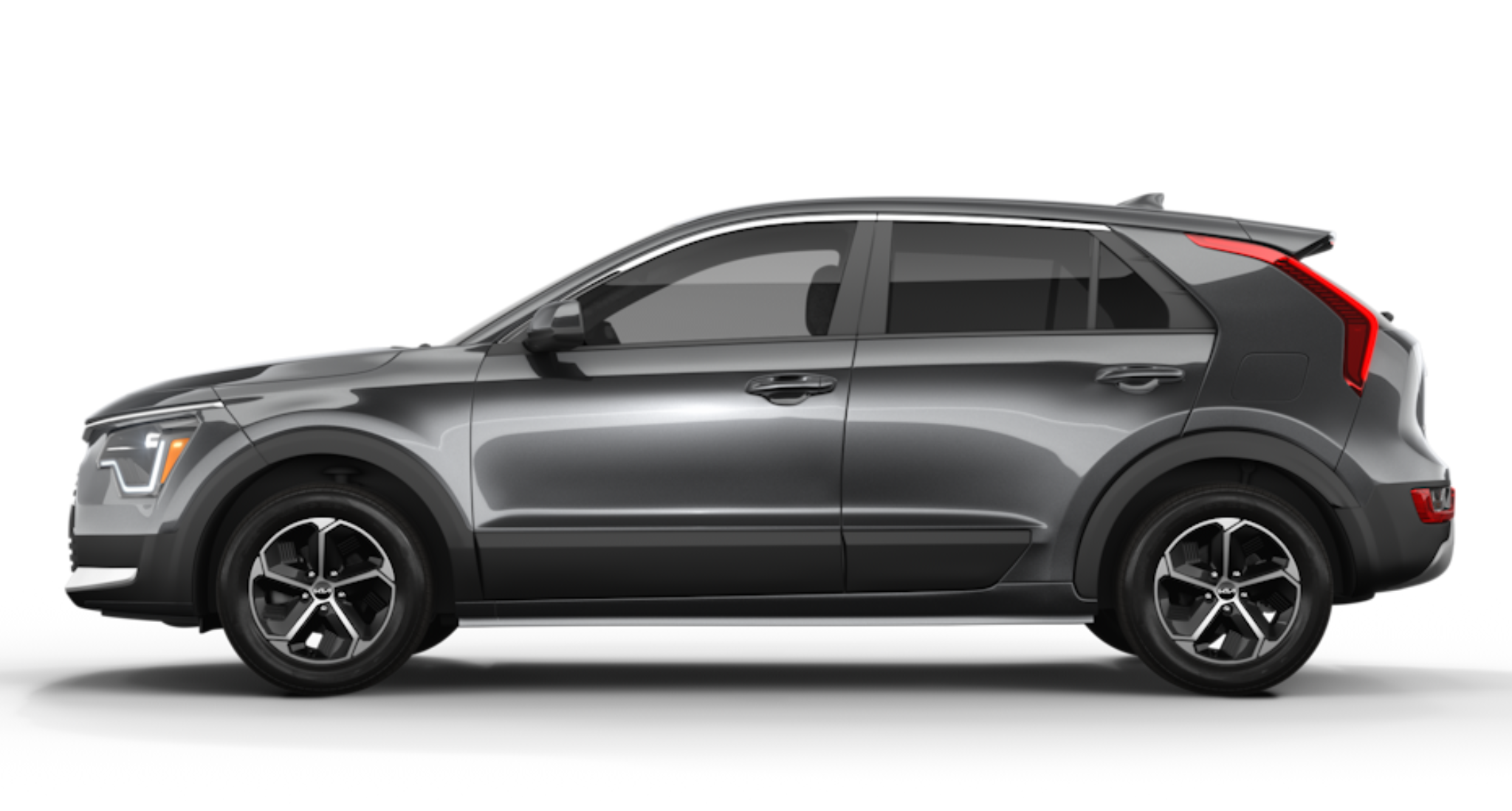 2025 Kia Niro LX FWD side profile in Steel Gray, displaying its sleek lines, 16-inch aero alloy wheels, and bold design with roof rails and chrome window trim.