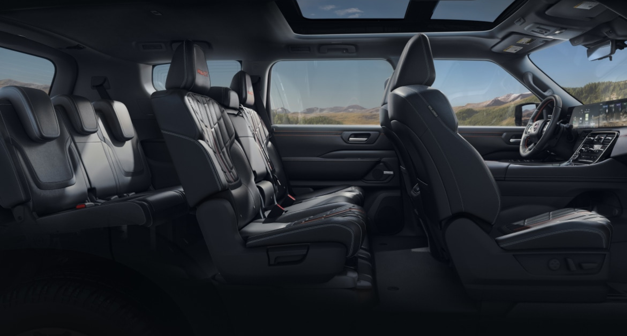 2025 Nissan Armada SV interior featuring three rows of premium leatherette seats, spacious eight-passenger seating layout, and panoramic sunroof with mountain view.