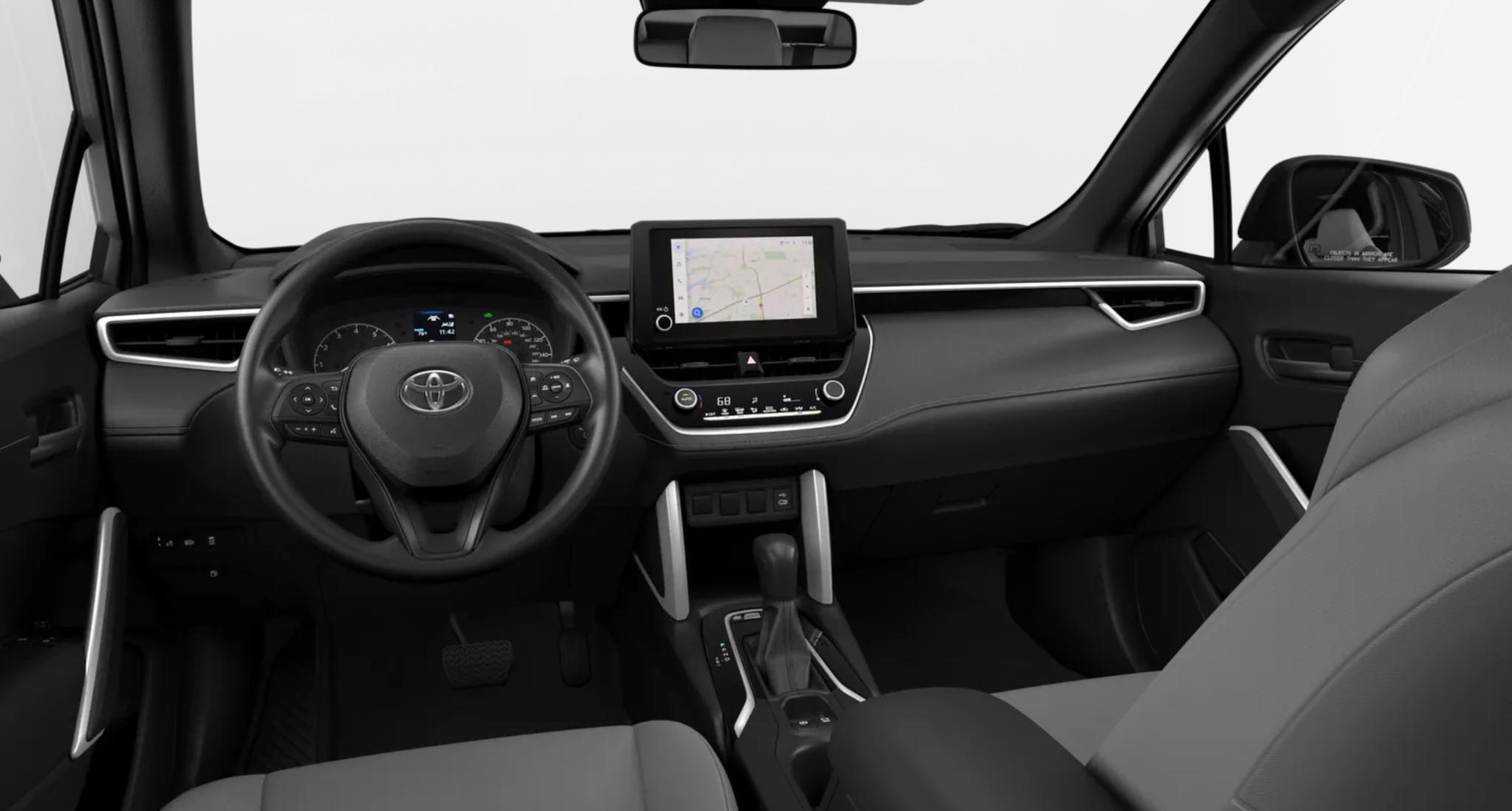 Dashboard and steering wheel of the 2025 Toyota Corolla Cross Hybrid AWD showcasing 8-inch touchscreen, wireless Apple CarPlay, climate controls, and modern instrument cluster.