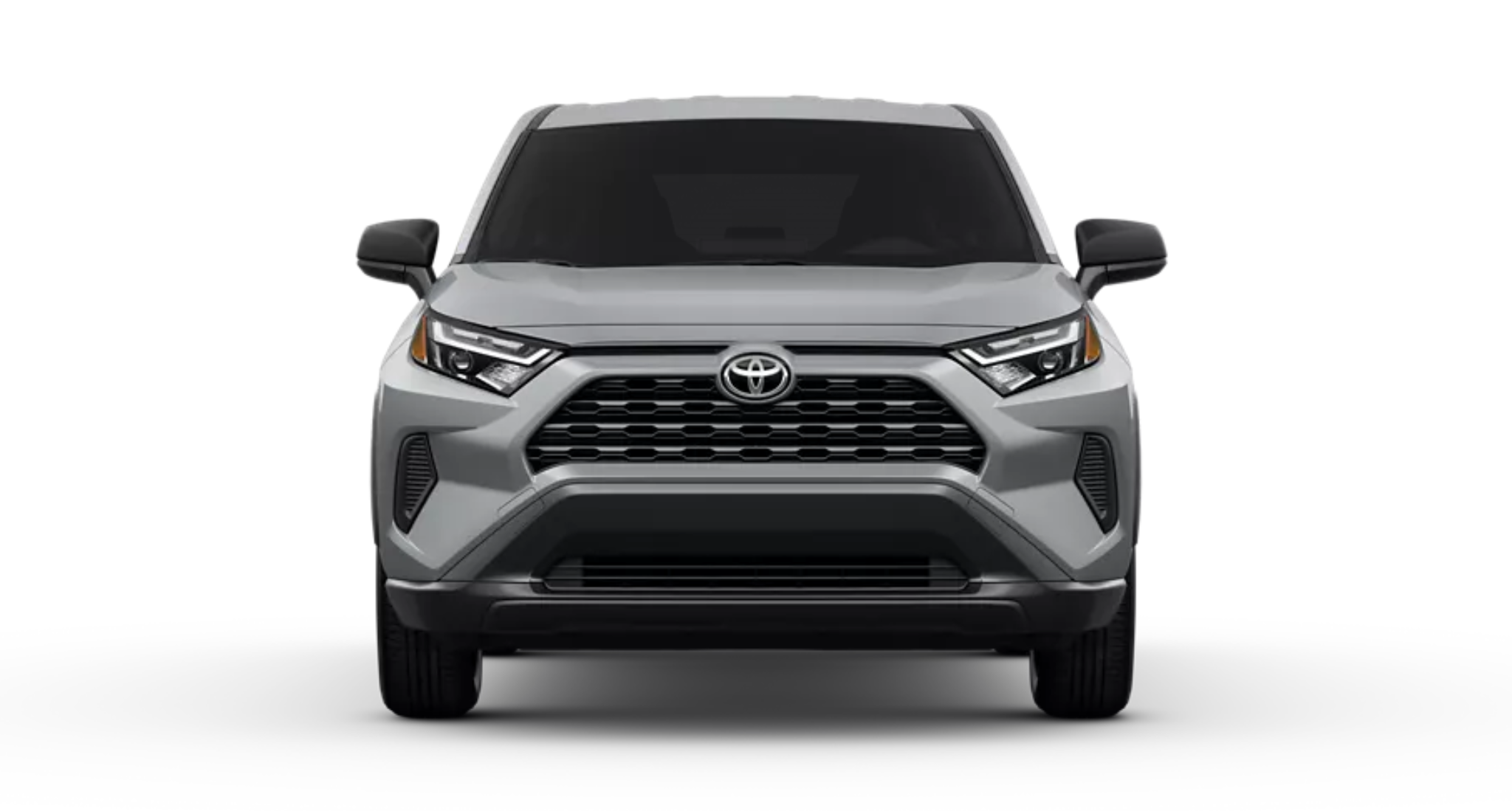 Front view of the 2025 Toyota RAV4 LE in silver, featuring a bold grille, LED headlights, and sculpted hood design.