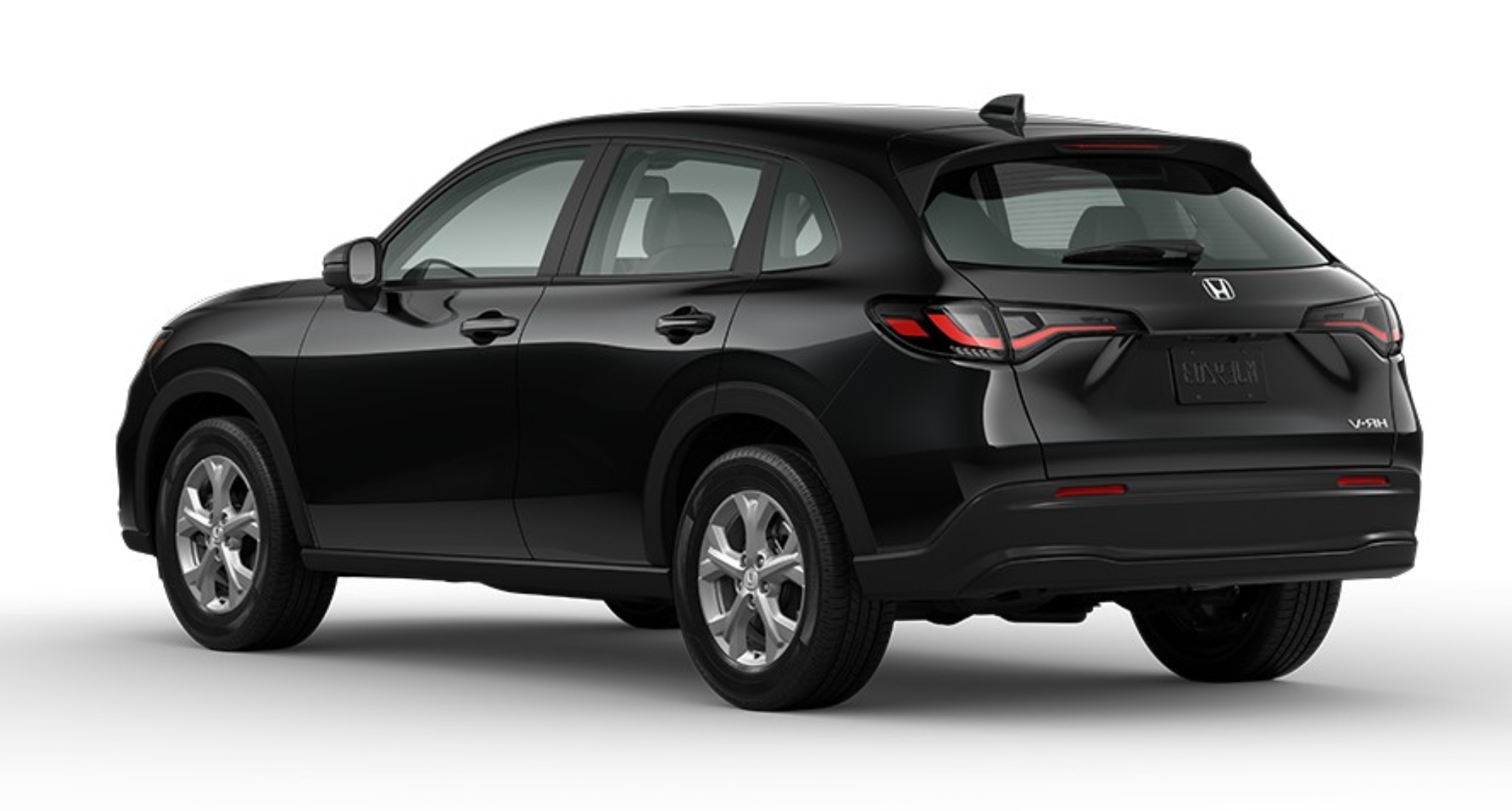 Rear exterior angle of the 2025 Honda HR-V AWD LX in Crystal Black Pearl, showcasing LED tail lights, sculpted rear hatch, and aerodynamic lines