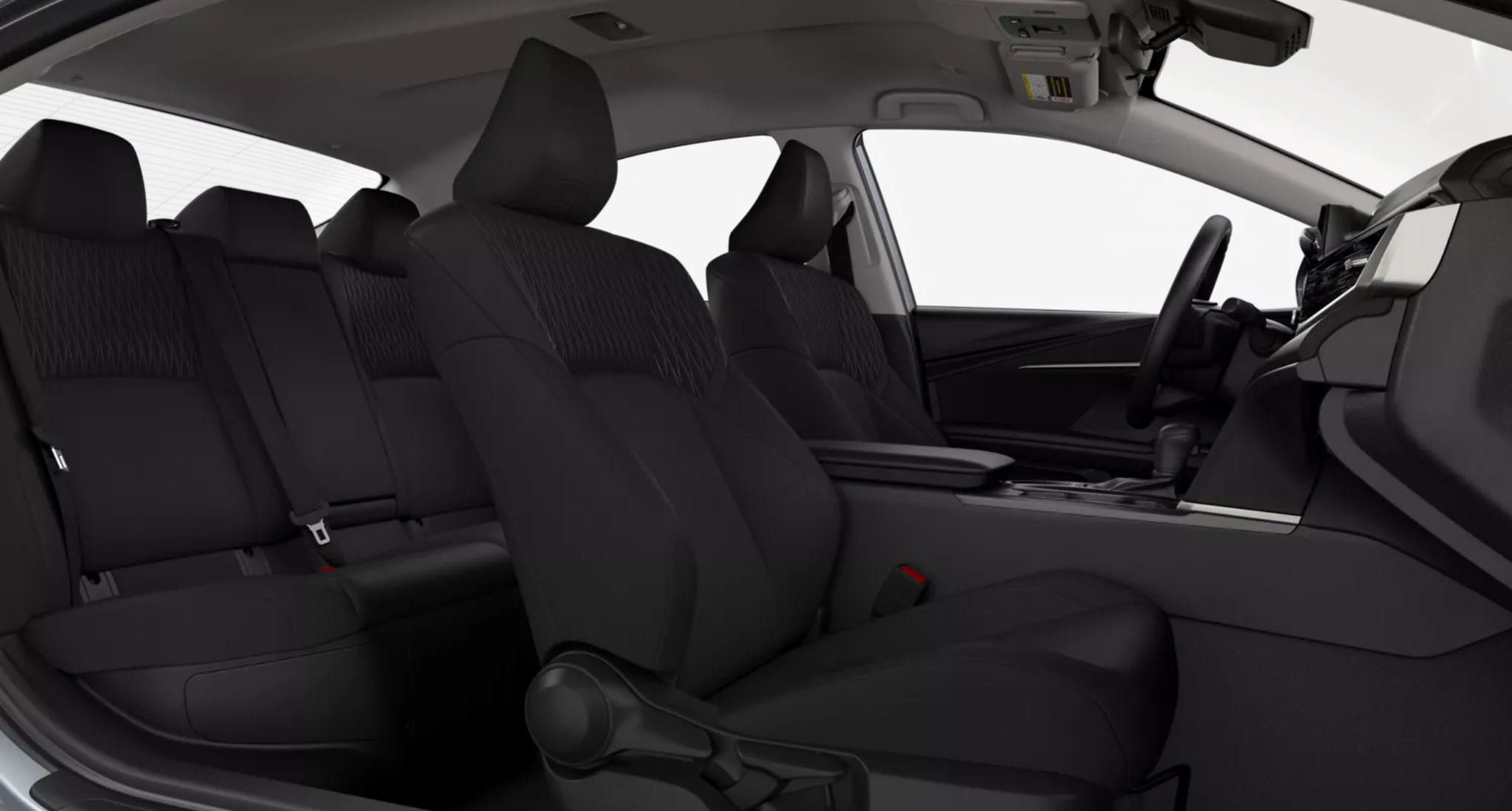 Interior view of the 2025 Toyota Camry LE showcasing fabric-trimmed front and rear seats with ample legroom and modern design.