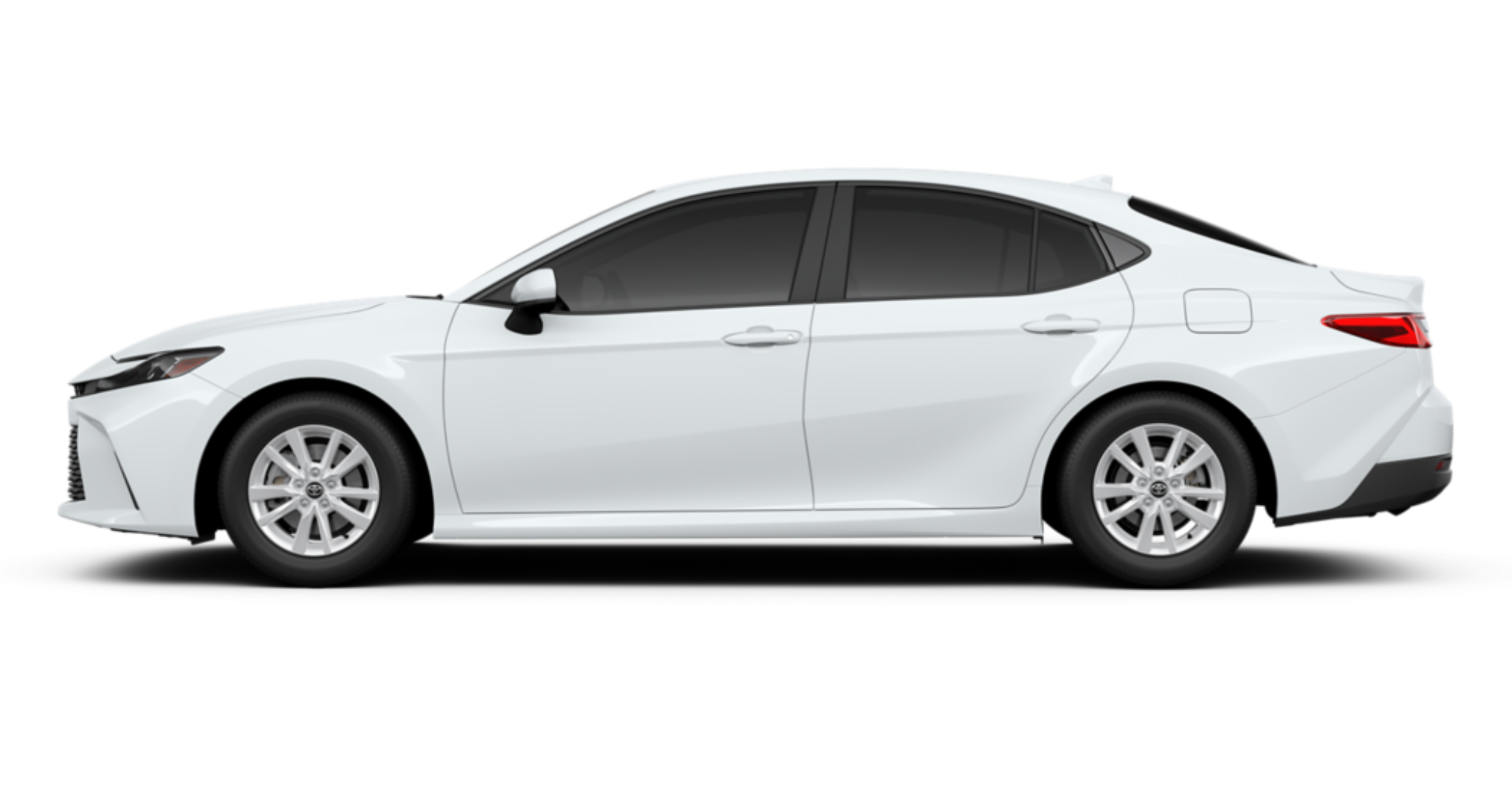 Side profile of the 2025 Toyota Camry LE FWD in white, highlighting its aerodynamic body, 16-inch alloy wheels, and sleek design.