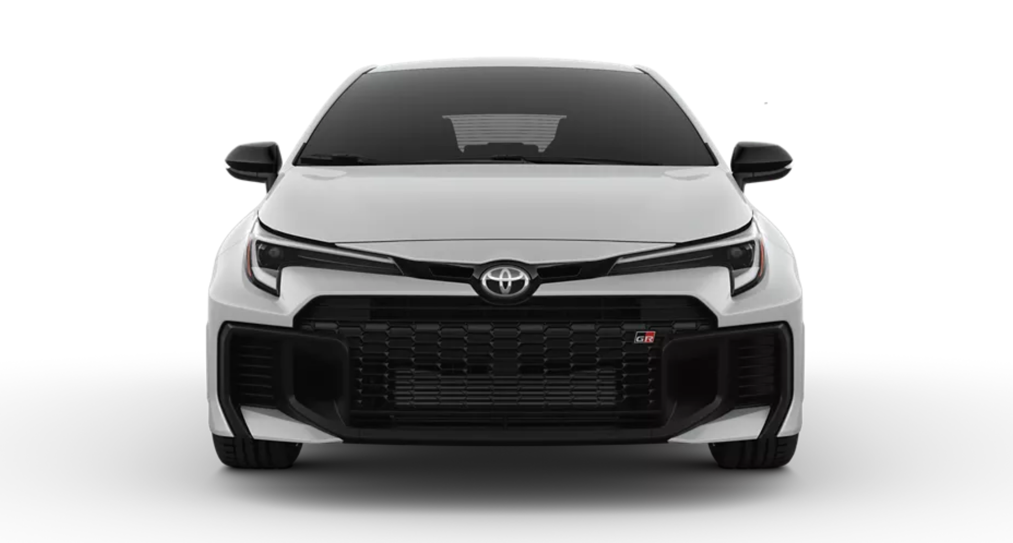 2025 Toyota GR Corolla Core Trim AWD front head-on view featuring the large black mesh grille, GR badging, aggressive bumper design, and aerodynamic sculpting for a sporty look.