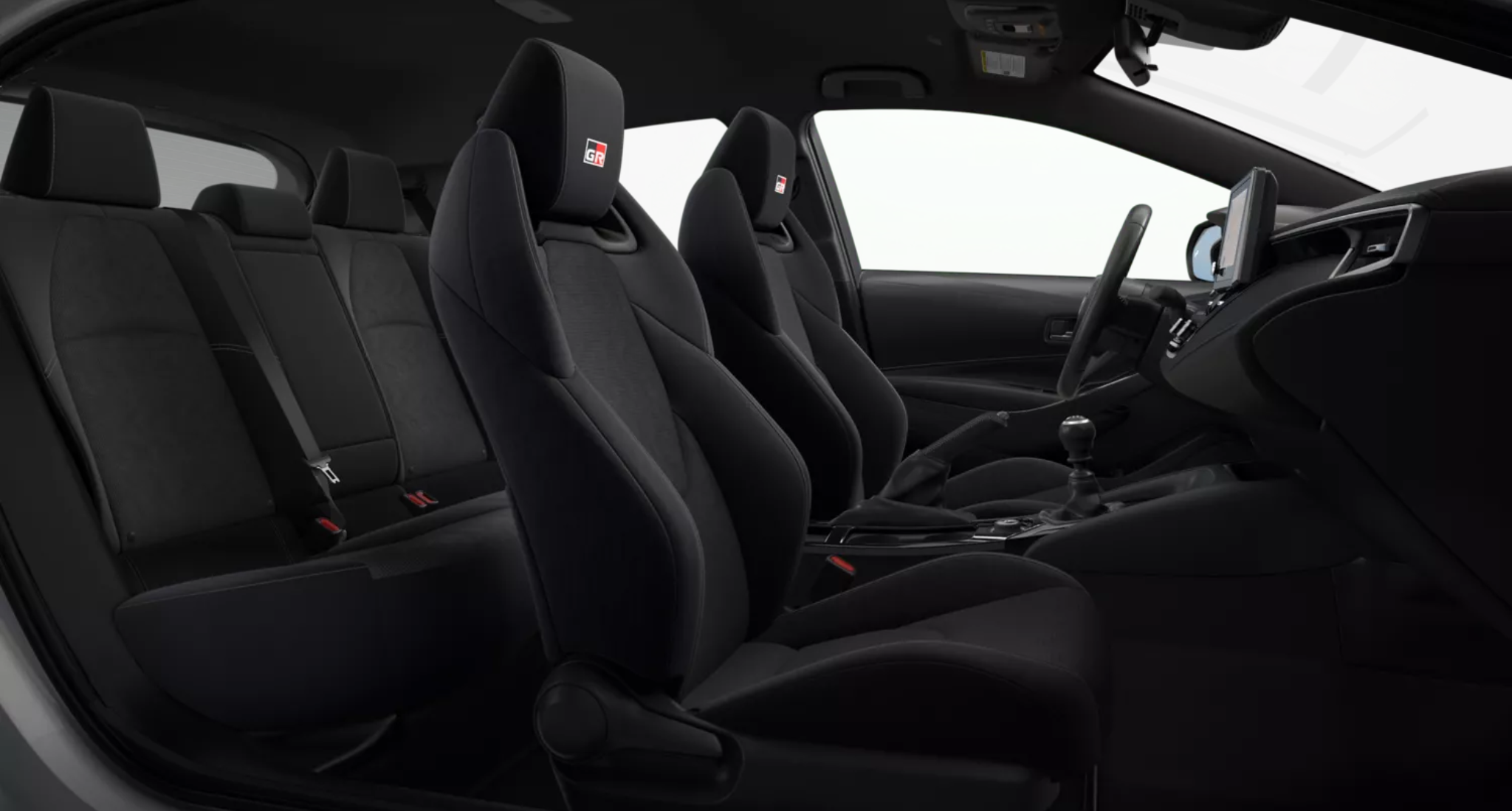 2025 Toyota GR Corolla Core Trim AWD rear passenger seats featuring black sport upholstery with contrast stitching, designed for comfort and support during performance driving.
