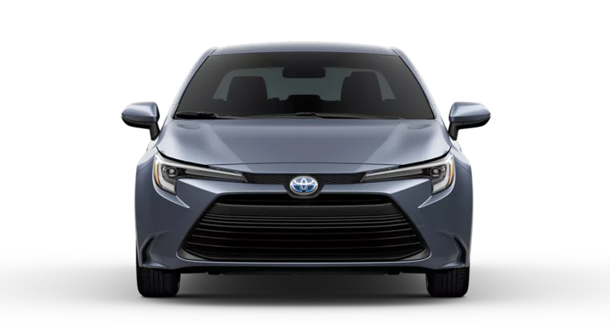 Front view of the 2025 Toyota Corolla Hybrid LE in a sleek metallic finish, highlighting its bold black front grille, sharp LED headlights, and aerodynamic design.