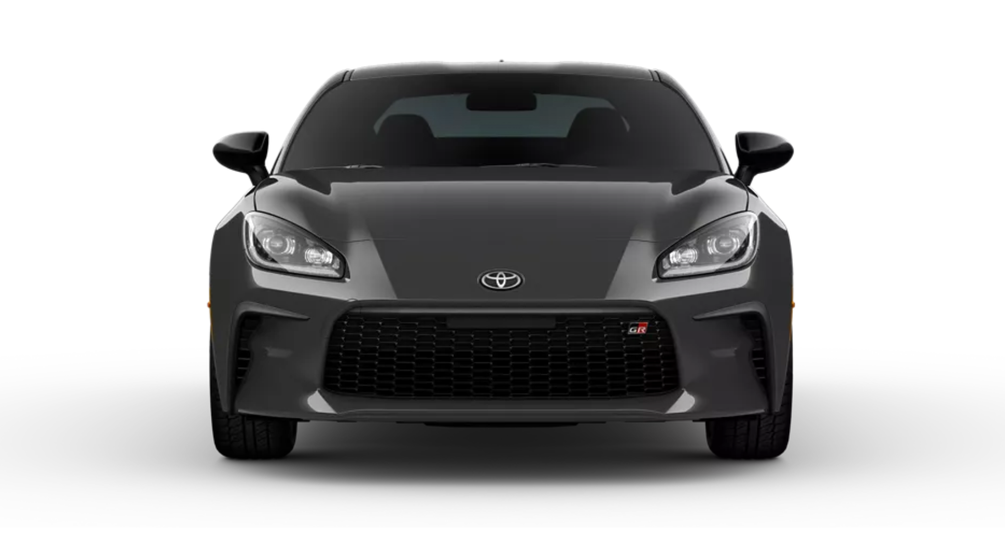 Front view of the 2025 Toyota GR86 in Magnetic Gray Metallic, highlighting its aggressive front fascia, wide black mesh grille with GR badge, and sleek LED headlights.