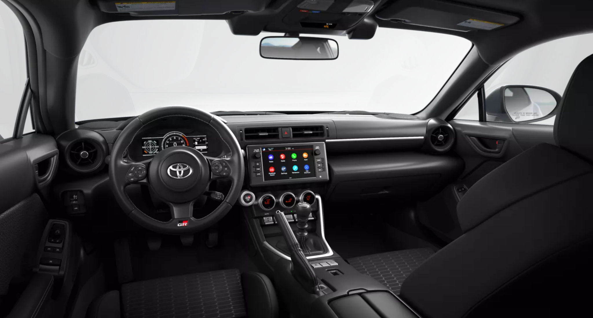 2025 Toyota GR86 driver cockpit featuring a GR leather-trimmed steering wheel, 7-inch digital gauge cluster, and 8-inch touchscreen infotainment system with Apple CarPlay and Android Auto integration.
