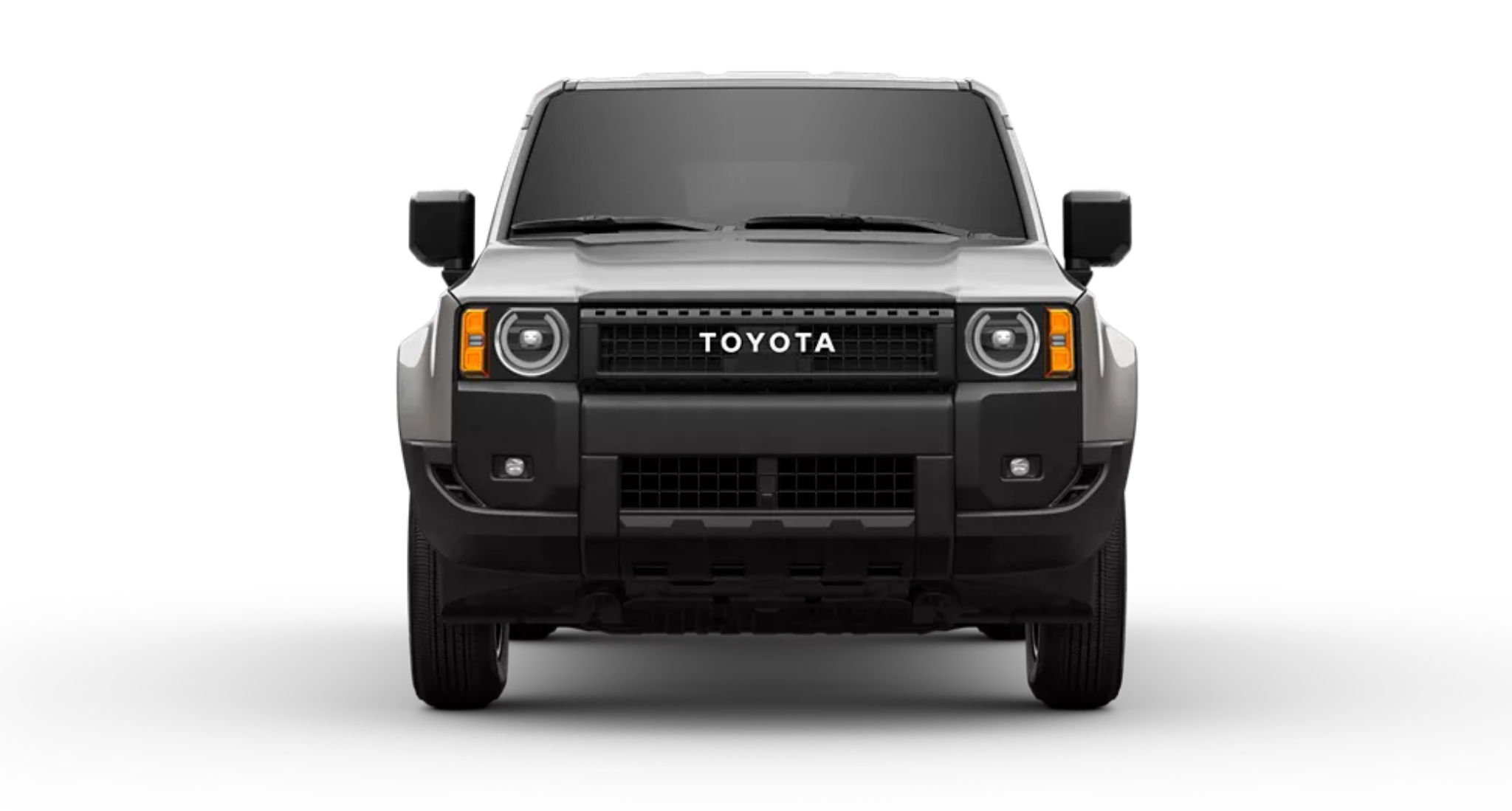 Front view of the 2025 Toyota Land Cruiser 1958 AWD with signature round LED headlights, bold Toyota grille, and skid plate protection.