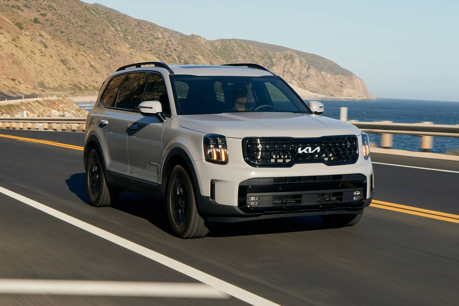 2025 Kia Telluride driving on the road demonstrating all-wheel drive and versatility.