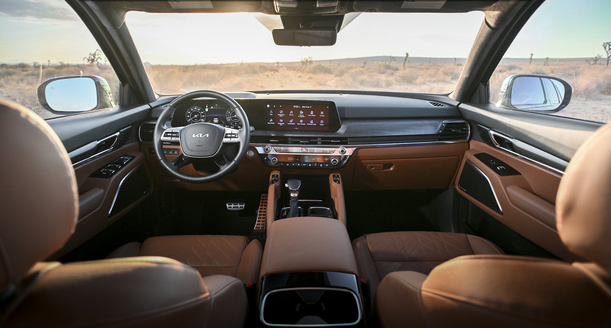 Interior dashboard view of the 2025 Kia Telluride featuring panoramic display and controls.