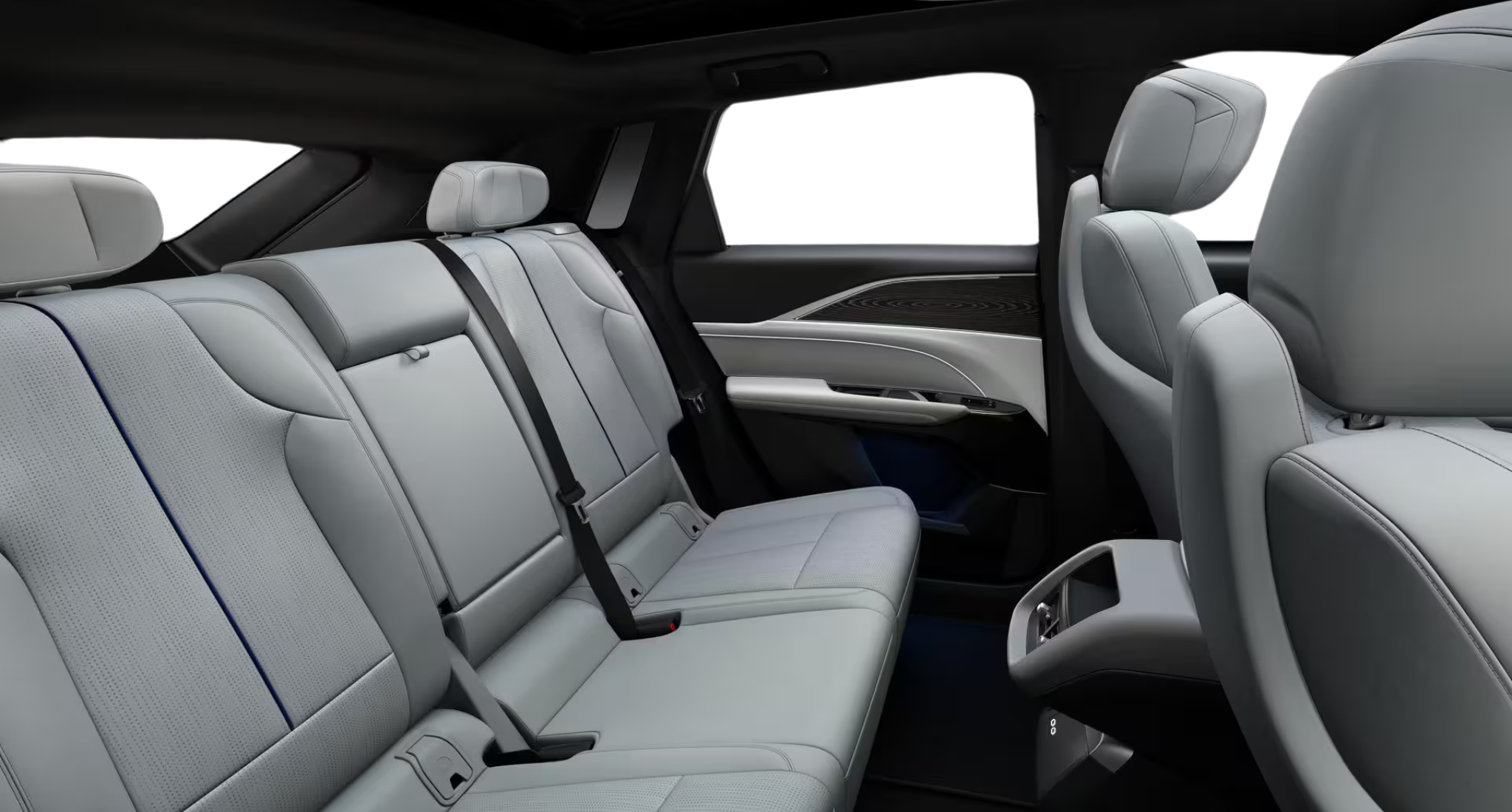 Rear passenger seating of the 2025 Cadillac Lyriq AWD EV Luxury 1 AWD showcasing spacious legroom, perforated leather seats, and upscale cabin materials designed for comfort and style.