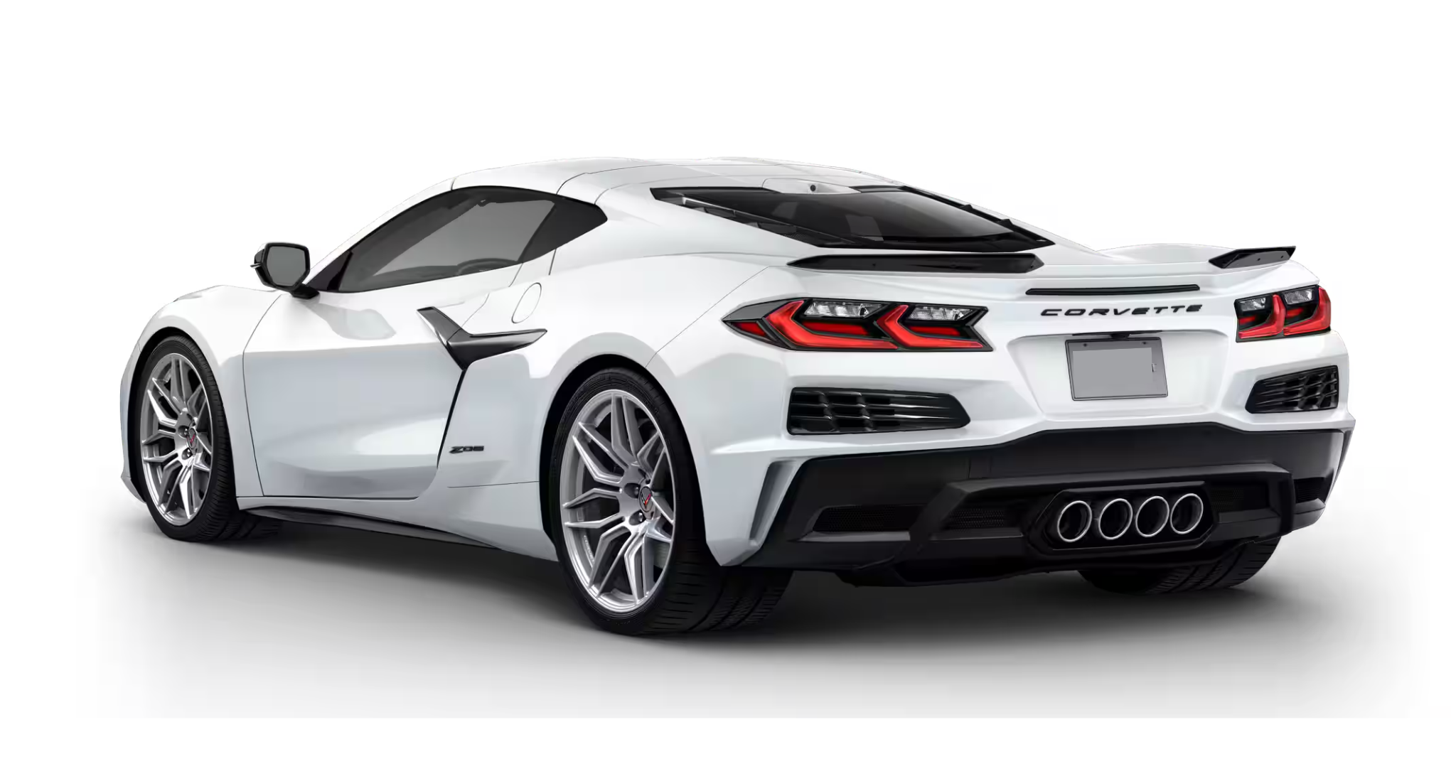 Rear angle of the 2025 Chevrolet Corvette Z06 in white with quad exhaust and carbon flash spoiler