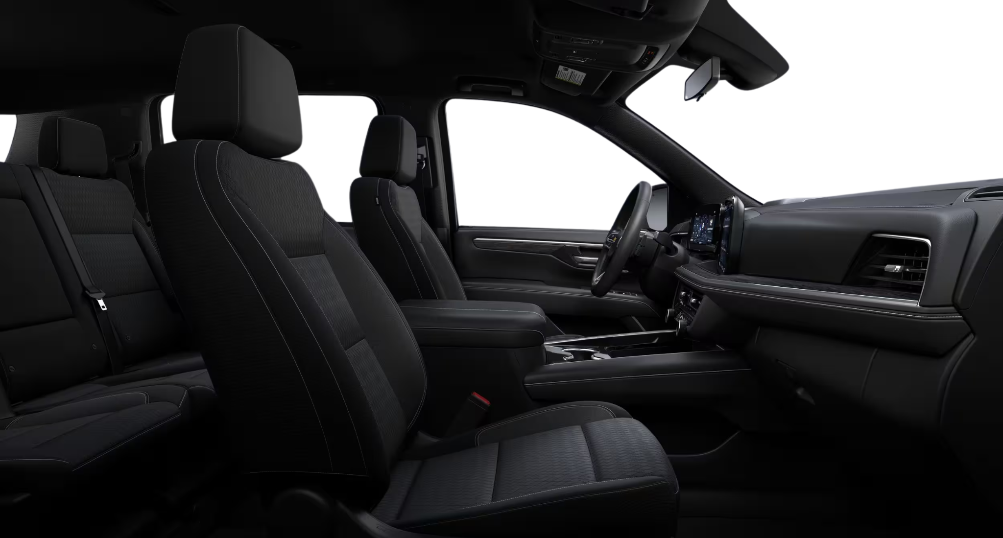 Side angle of the 2025 Chevrolet Suburban LS 4WD interior showing spacious black cloth seats and modern cabin design.