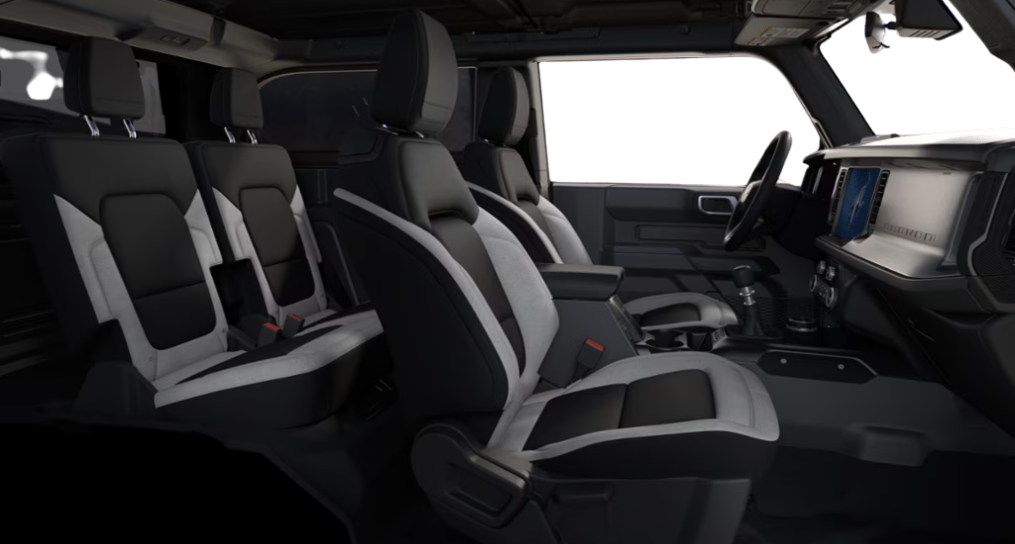 Side angle of the 2025 Ford Bronco Base 4x4 interior showing black-and-gray cloth seating with front and rear rows