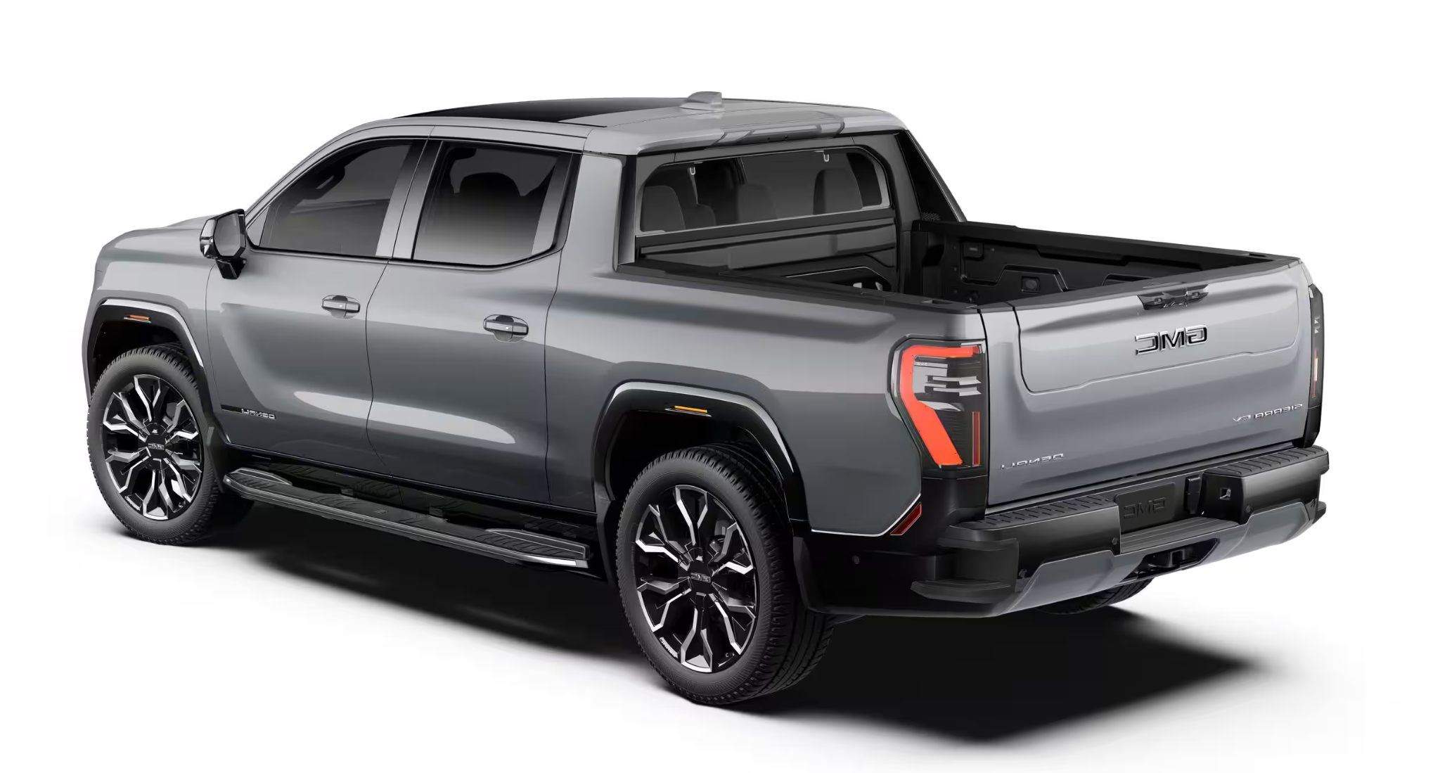 Rear angle of the 2025 GMC Sierra EV Denali 4WD featuring modern taillight design, MultiPro tailgate, and spacious truck bed.