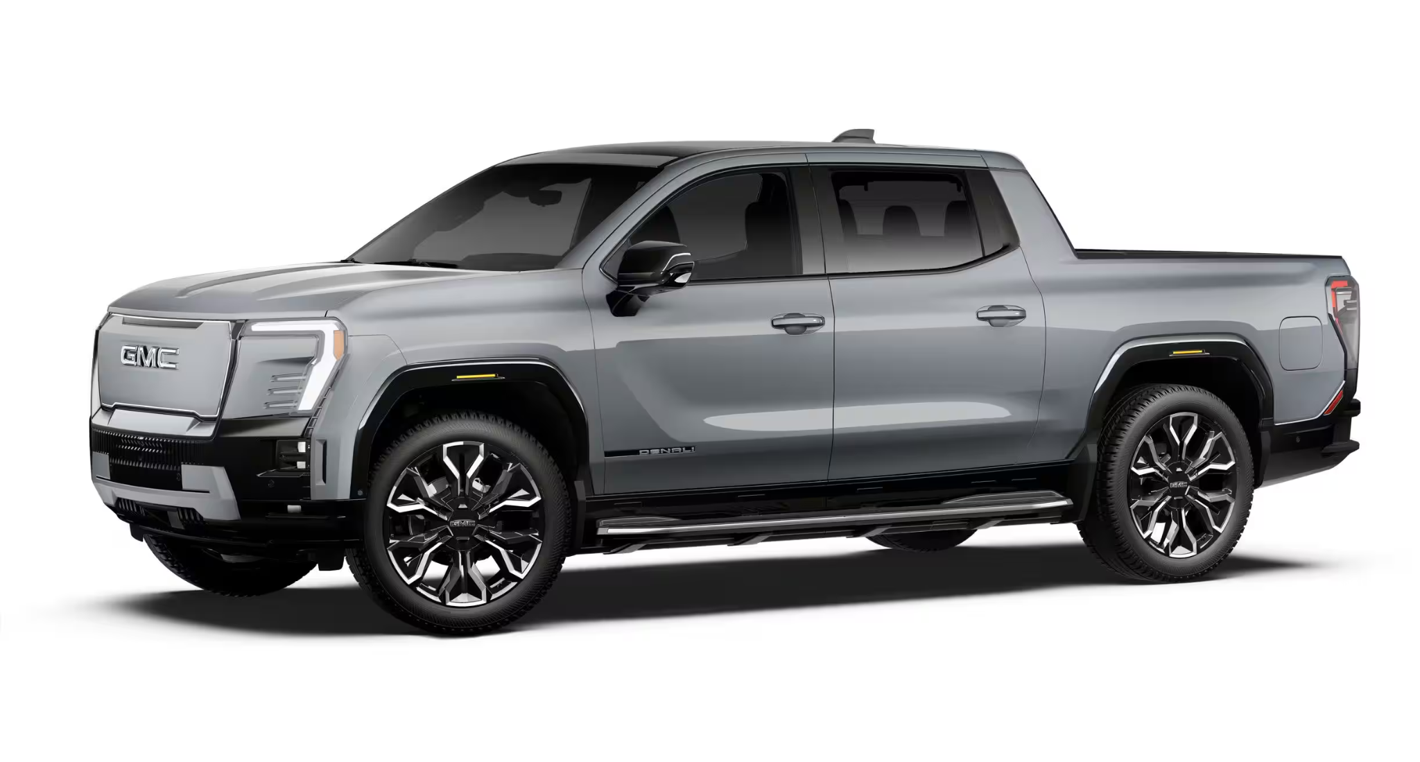Side profile of the 2025 GMC Sierra EV Denali 4WD in gray metallic finish, highlighting bold lines, chrome trim, and premium wheels.
