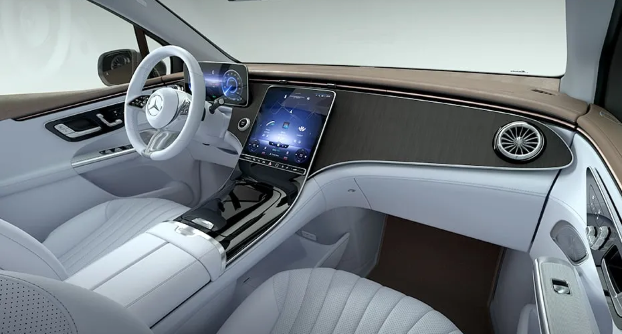 Interior front cabin of the 2025 Mercedes-Benz EQE 350 4MATIC SUV featuring a curved OLED touchscreen, digital cluster, and luxury wood trim.