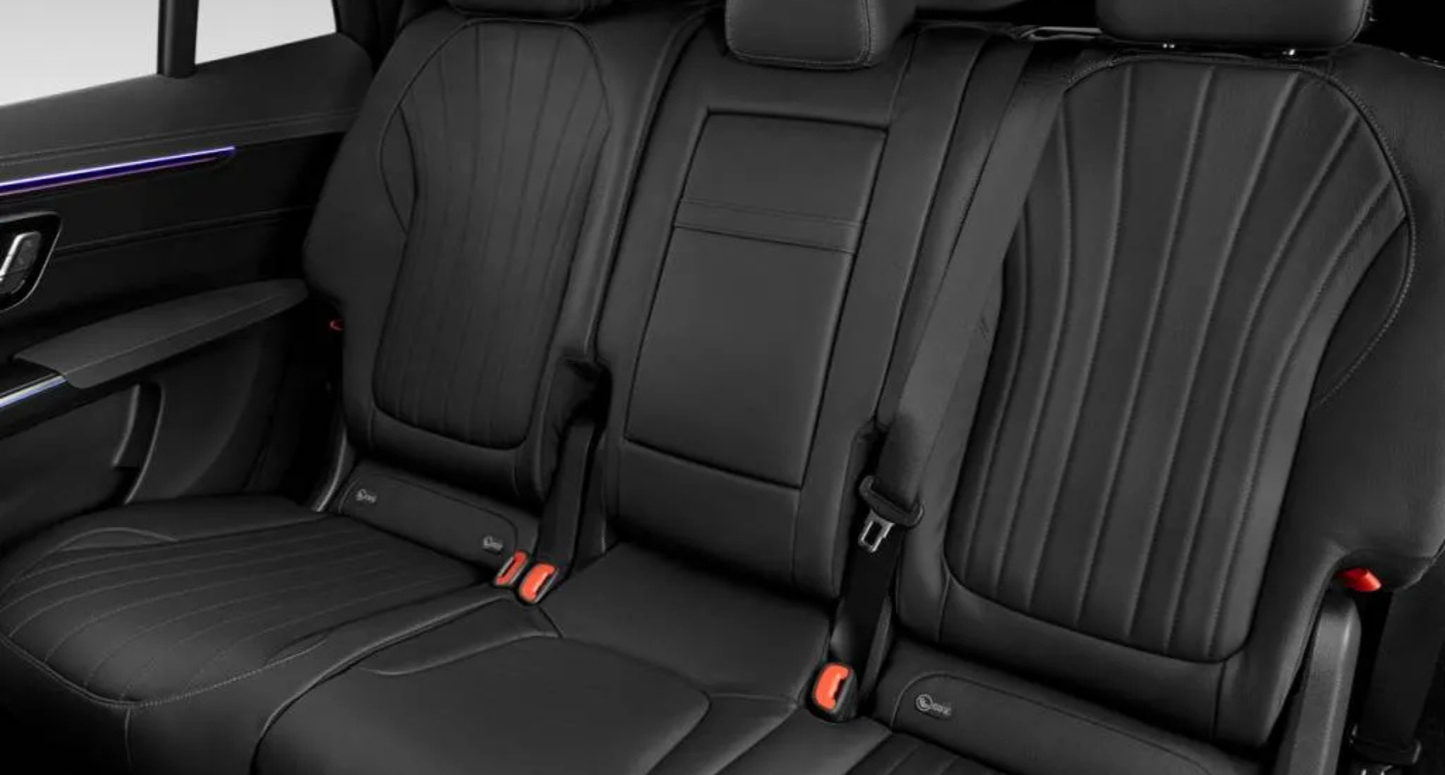 Spacious black leather rear seats of the 2025 Mercedes-Benz EQS with premium stitching and ambient door lighting in an all-electric luxury sedan