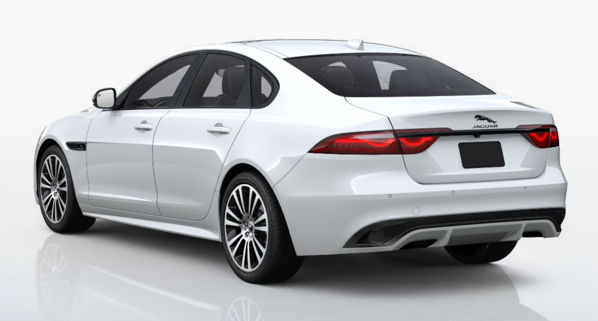 Rear angle of the 2024 Jaguar XF RWD R-DYNAMIC SE in Fuji White with LED tail lights and dual exhaust finishers