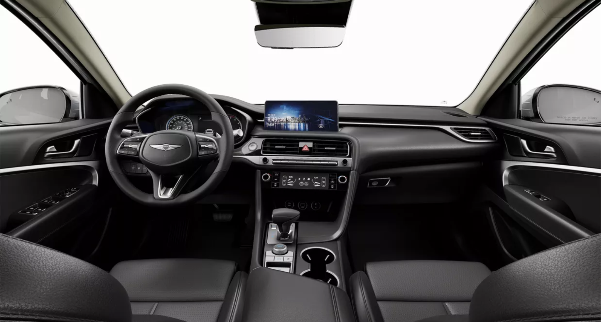 Driver-focused interior of the 2025 Genesis G70 RWD with touchscreen display, leather steering wheel, and modern console design