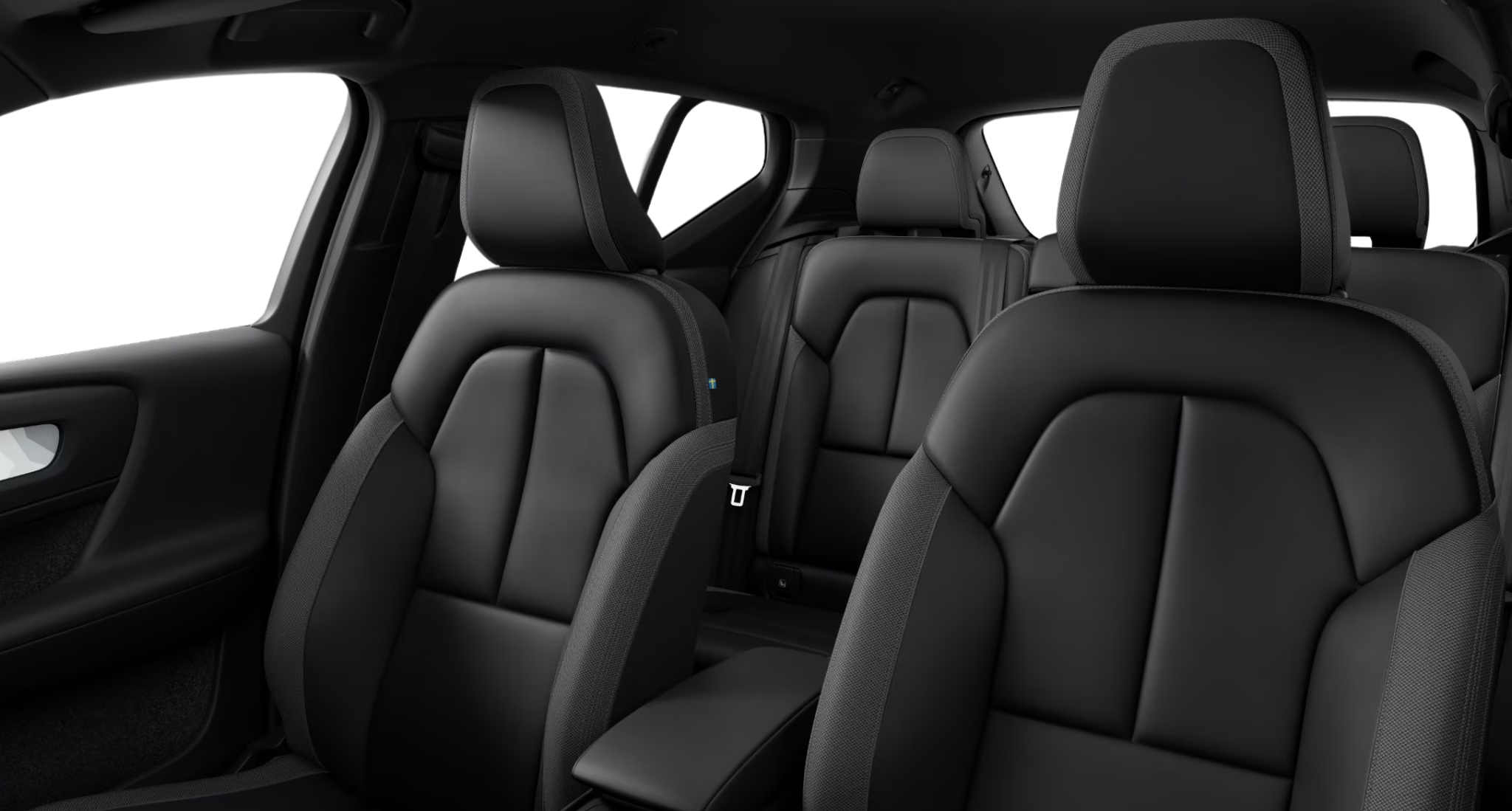 Front and rear seating inside the 2025 Volvo EX40 AWD Core with black premium cloth seats and modern Swedish interior styling.