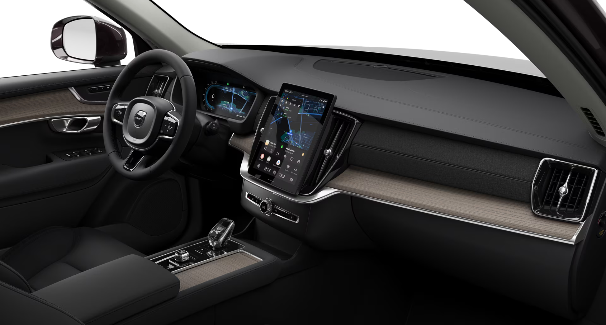 Driver-focused dashboard of the 2025 Volvo XC90 AWD Core featuring a digital display, Google-powered infotainment, and Orrefors crystal gear selector.